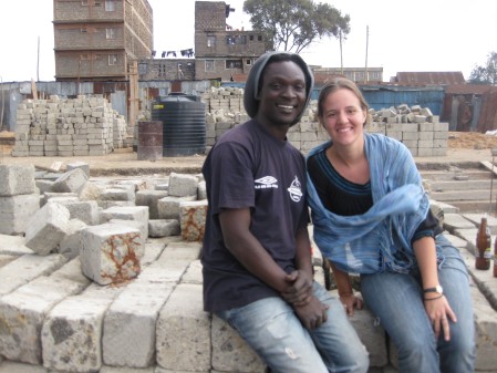 Austin and Stephanie, sitting on the foundation of the school they are working together to build
